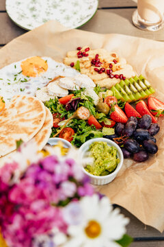 Colorful brunch platter with fried eggs and fresh fruit