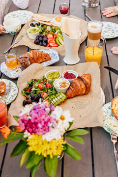 Friends having a delicious breakfast brunch together outdoors