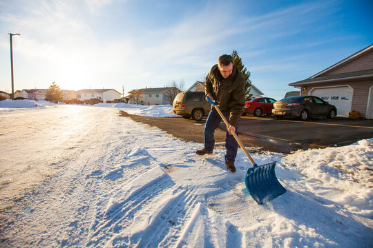 An elderly man Shovels snow in northern Alberta