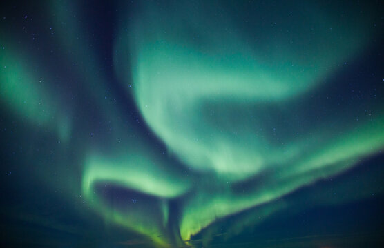 Vibrant green aurora borealis in the night sky