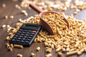 Obraz premium Wood Pellet Fuel Scoop With Calculator for Energy Cost Calculation and Biomass Heating Budgeting
