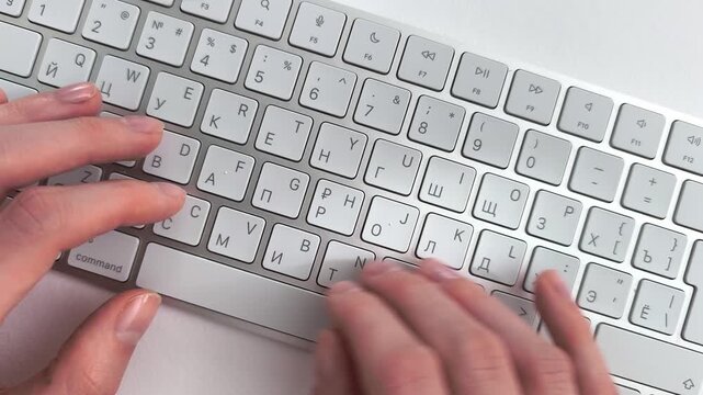 Online education typing on keyboard by a student attending a remote lecture. Female hands take digital notes during a webinar or university internet training course. View from above captures