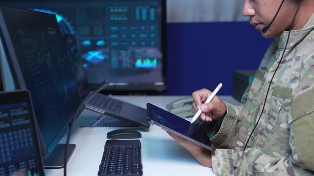 air traffic controller working on radar flight tracking screen in control room.