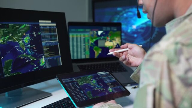 Air Force professional monitoring flight data and radar in an airport control tower, technology, air traffic control, navigation, safety, and precision.