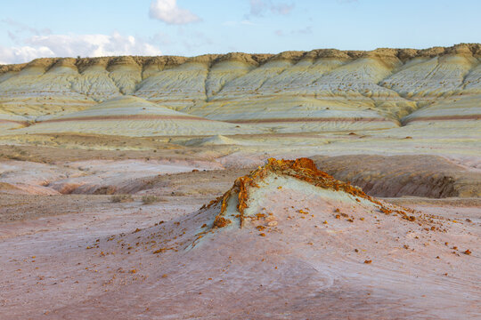 View of the colorful layered geological formations of Kyzyl Kup, known as Tiramisu, in the desert landscape of Karakiya District, Mangystau Region, Kazakhstan.
