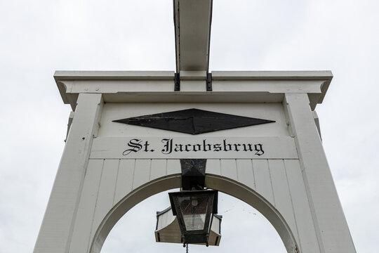View of the St. Jacobsbrug drawbridge with its white wooden frame, black diamond plaque, and hanging lantern in Monnickendam, North Holland, Netherlands.