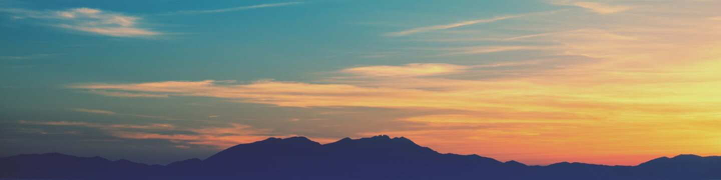Silhouette of mountains against the sunset sky