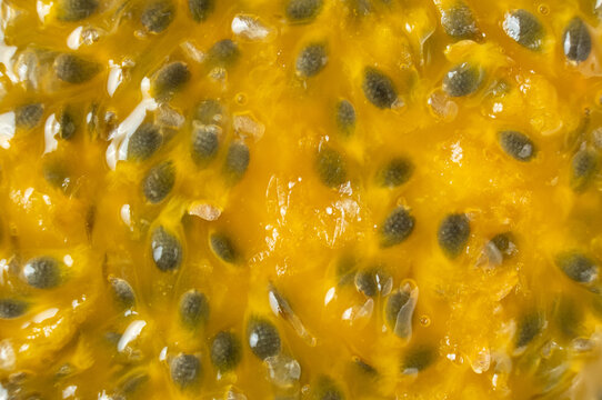 Abstract background texture of ripe passion fruit pulp with seeds