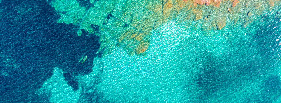 Top view of the sea and island. Sea surface. The texture of water and rocks
