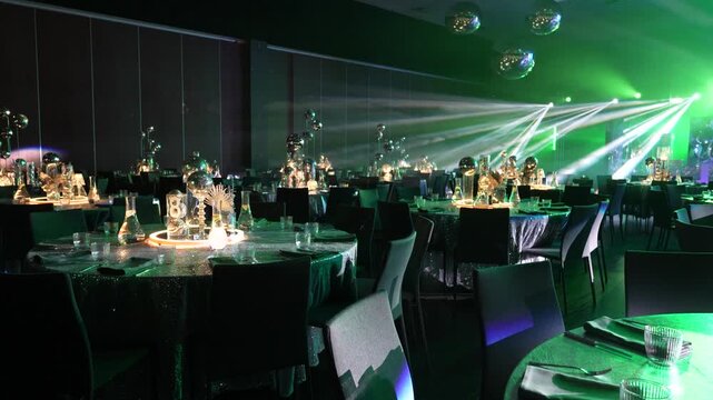 Elegant banquet hall with beautifully arranged tables, sparkling centerpieces, and vibrant lighting creating an inviting atmosphere for a festive celebration or event