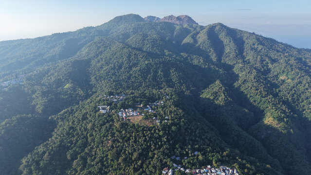 Aerial view of mountain village surrounded by tropical rainforest, Palue Island
