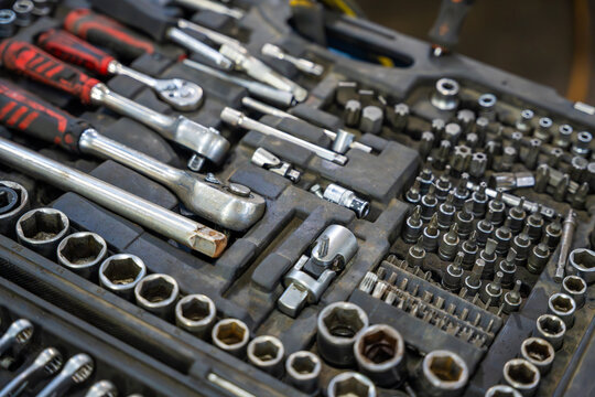 Mechanic tool set with ratchets sockets bits and wrenches in auto repair shop. Professional equipment represents car maintenance and vehicle repair service