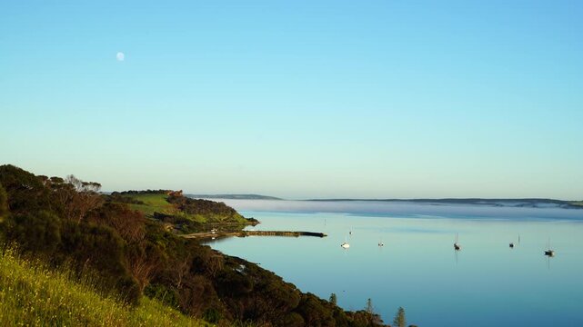 Low-lying fog drifting across calm waters at Beatrice Point, Kingscote, Kangaroo Island