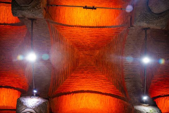 Istanbul, Turkey - August 28, 2026: Architectural ceiling view of illuminated brickwork with orange lighting in a historic building showcasing intricate design elements