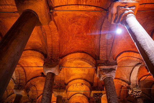 Architectural interior of the Basilica Cistern in Istanbul, featuring rows of columns and vaulted ceilings illuminated by warm lighting
