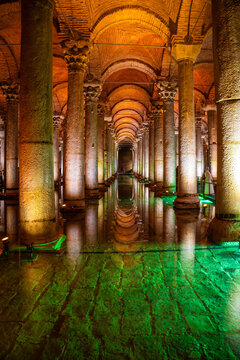  Ancient underground Basilica Cistern in Istanbul with stone columns and illuminated green water reflecting the architecture in a historical setting