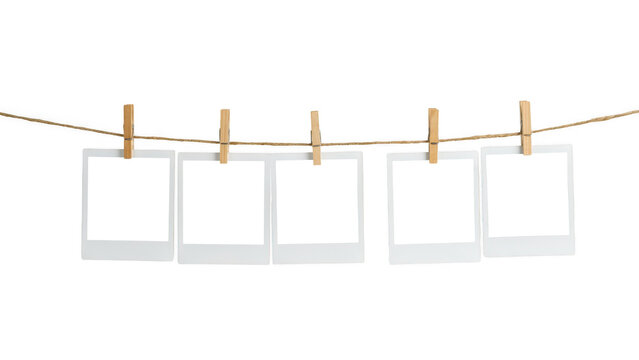 Five blank photo frames hanging on a rope isolated on transparent background