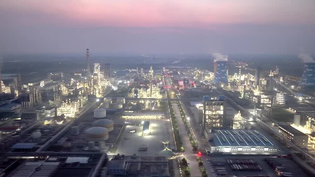 Panoramic view of illuminated petrochemical plant at dusk