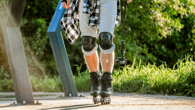 Rollerblader skating on a sunny trail with protective gear