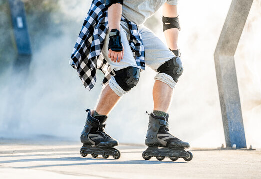 Person rollerblading on concrete path during sunny morning