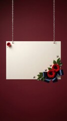 Obraz premium Blank card hanging by chains decorated with red poppies and ribbon