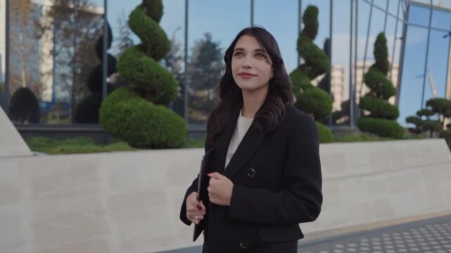 Thoughtful businesswoman standing outdoors in urban setting