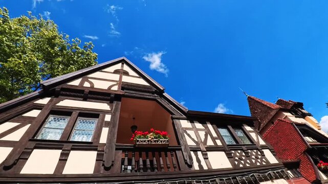 Upward View of a Traditional Romanian Germanic Style Building With Flower Filled Windows and Steep Roof, Sinaia, Romania - STEADY VIDEO - NO AUDIO