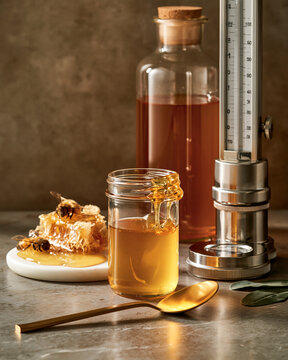 Honey sample with refractometer and gold spoon highlighting food authenticity testing premium ingredients and luxury editorial quality
