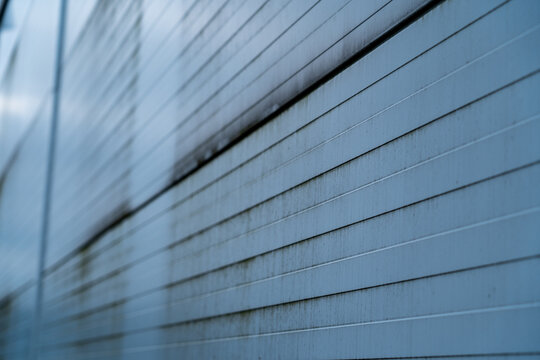 Metal siding featuring horizontal lines and patterns, creating an industrial background texture