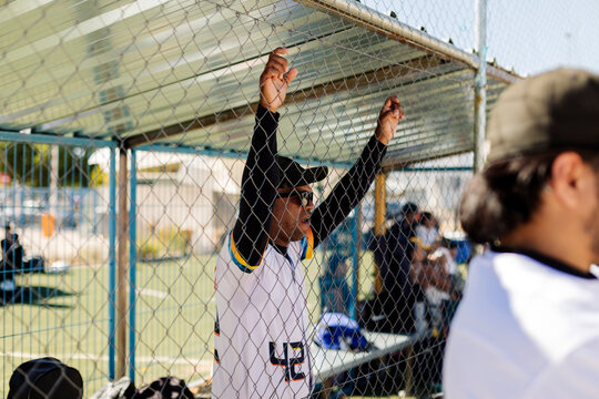 Baseball player watching game from dugout
