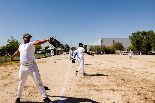 Man pitching softball during outdoor game or practice
