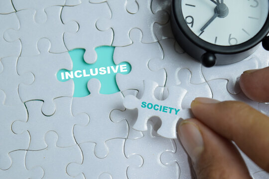 Piece of jigsaw puzzle inclusive society phrase. For the urgent need for inclusion, equality and diversity