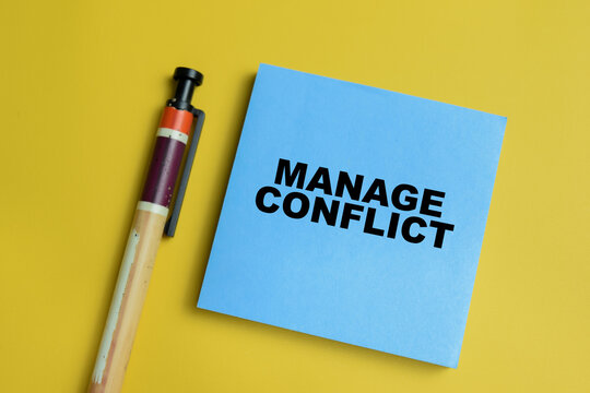 Concept of manage conflict write on sticky notes isolated on table. For conflict resolution