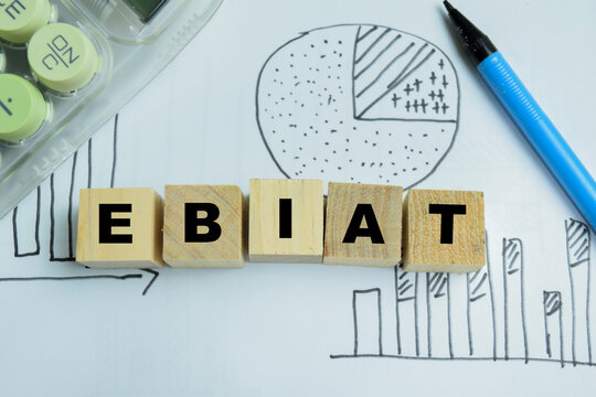 Concept of EBIAT - Earnings Before Interest After Taxes text on wooden blocks.