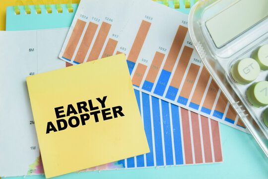 Concept of early adopter write on sticky notes isolated on table.