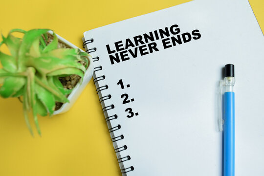 Concept of learning never ends write on book isolated on table. For life long educational