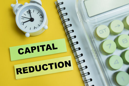 Concept of capital reduction text on wooden blocks. For financial risk management