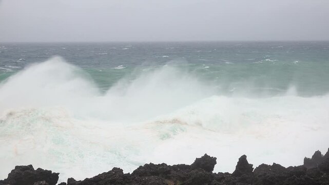 Ferocious Hurricane Waves Crash Against Cliffs Sending Spray Into Air