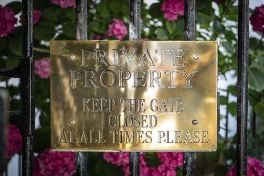 Shiny gold sign with the words Private Property Keep the Gate Closed at all times please, Kynance Mews, Royal Borough of Kensington and Chelsea, London, Great Britain, England, Great Britain