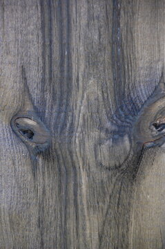 Close-up of aged weathered wooden planks with cracked, peeling, and rough natural grain. Gray and brown tones create a rustic, distressed surface texture suitable for backgrounds, vintage designs, con