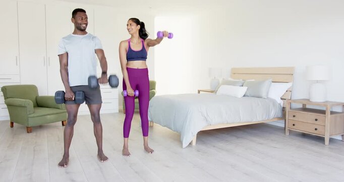 Lifestyle videos indoor of people doing activities at home, exercising together, couple lifting dumb