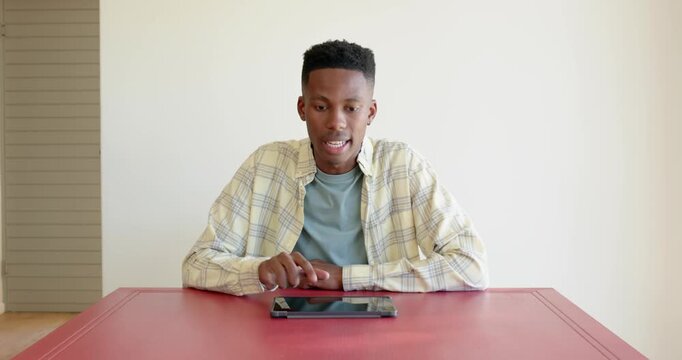 Close up of people talking to the camera, using tablet, young man sitting at table in casual home se