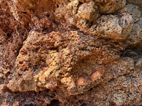Natural rock formation showing a weathered and porous texture, creating an abstract pattern and detailed background in manacor, balearic islands, spain