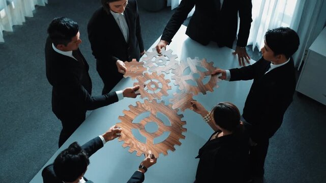 Top view of smart business people gather wooden cog together at meeting. Group of project manager helping and team working to solve problem at meeting room or workplace. Represent unity. Directorate.