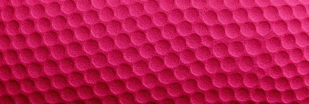 Rosa pinke Oberfl&auml;che mit gleichm&auml;&szlig;igem Muster aus Sechsecken als abstrakter Texturhintergrund im Querformat