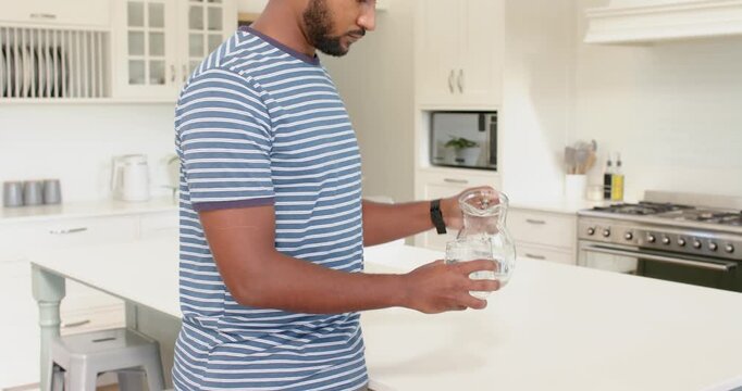 Lifestyle videos indoor of people doing activities at home, drinking glass of milk, man standing in