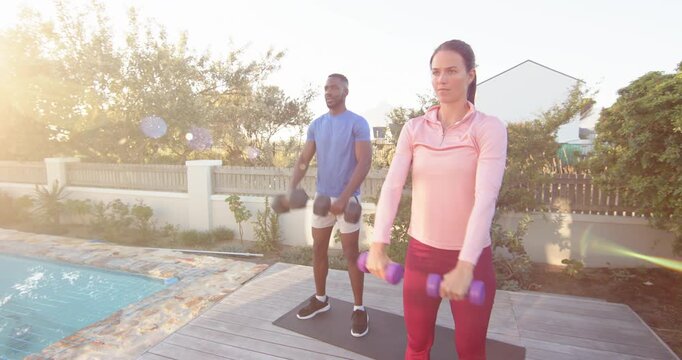 Lifestyle videos outdoor of people doing activities, exercising outdoors, man and woman lifting dumb