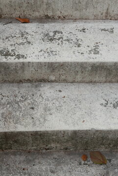 Close-up of weathered and stained concrete outdoor steps