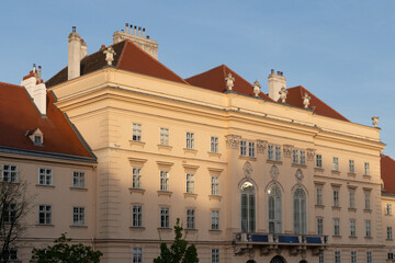 Ornate building facade with red tiled roofs © iBennn