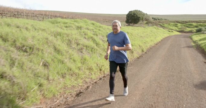 Lifestyle videos outdoor of people doing activities, jogging on rural trail, man enjoying outdoor ex